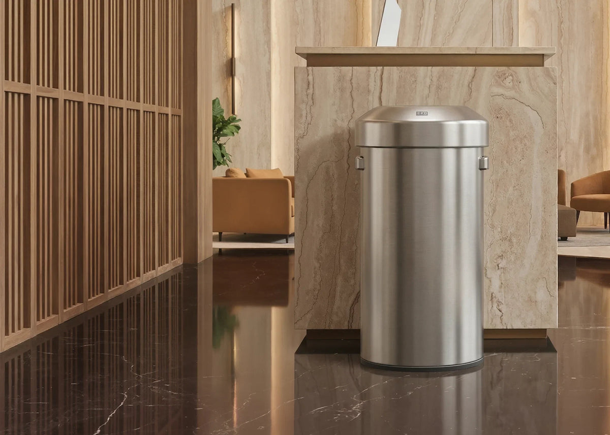 Brushed stainless steel EKO open-top commercial bin in a marble hotel lobby