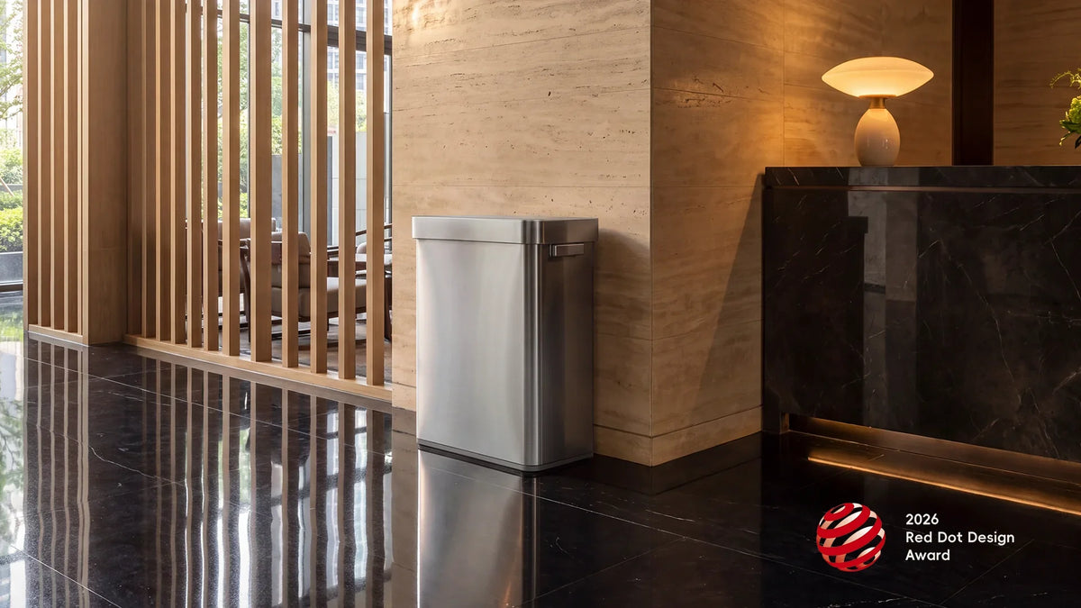 Stainless steel EKO Deluxe Mirage recycling sensor bin in a hotel lobby with the 2026 Red Dot Design Award badge