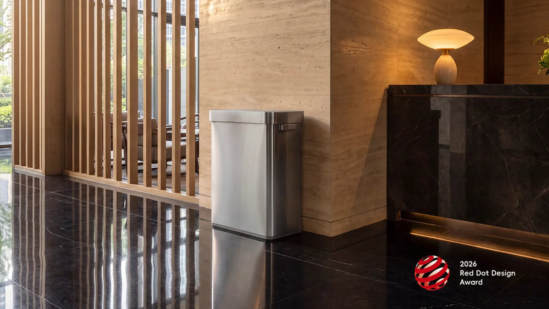 Stainless steel EKO Deluxe Mirage recycling sensor bin in a hotel lobby with the 2026 Red Dot Design Award badge