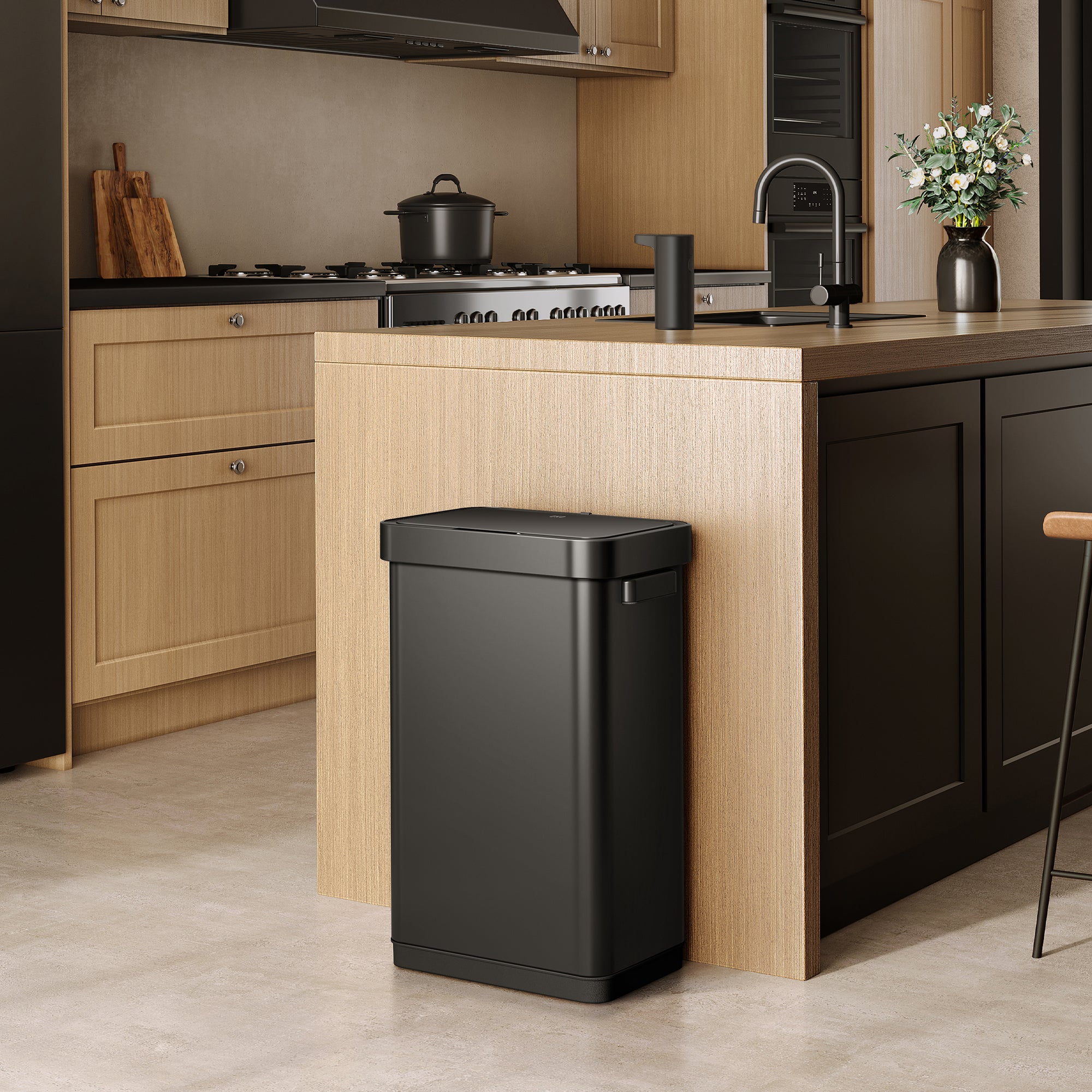 EKO trash can next to a modern kitchen counter, surrounded by light wood cabinetry and appliances.