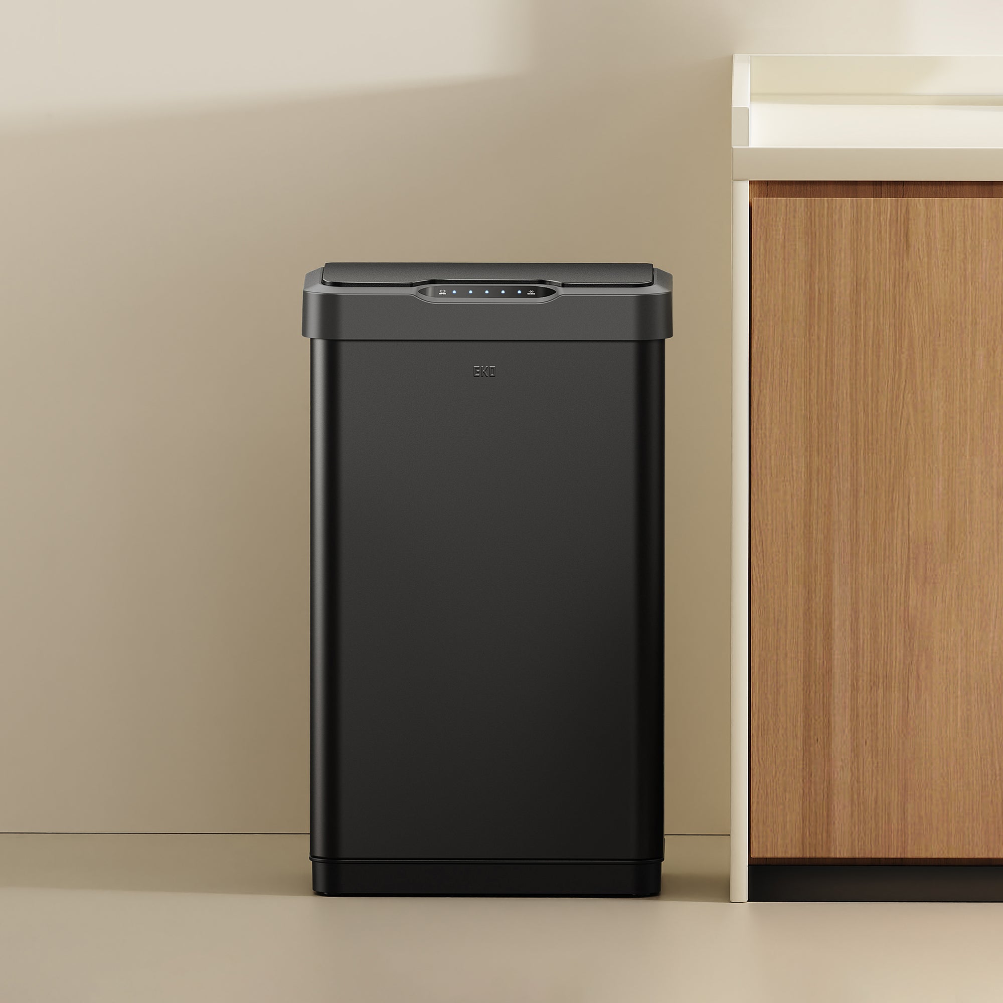 EKO trash can in a kitchen setting with a countertop and cabinets.