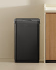 EKO trash can in a kitchen setting with a countertop and cabinets.