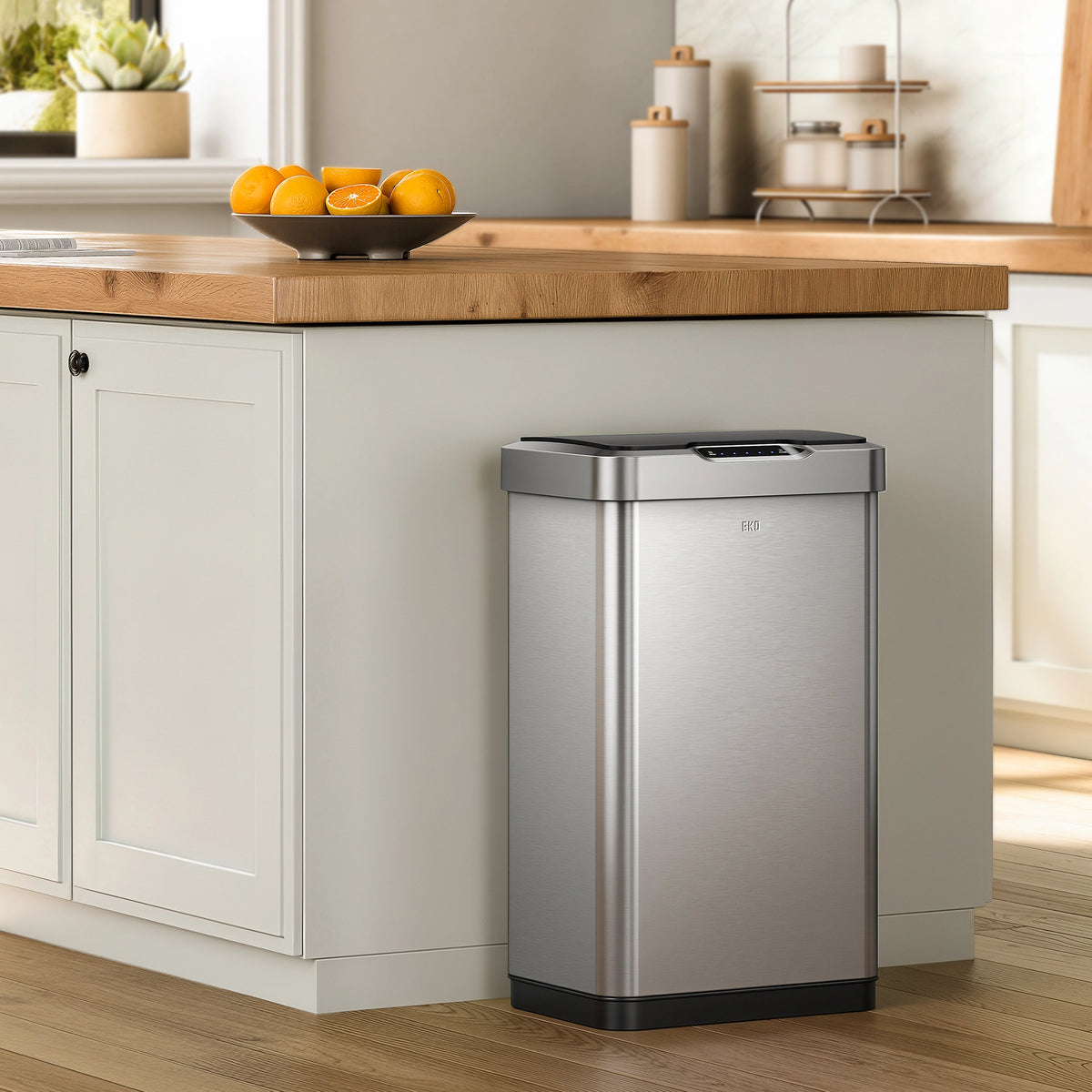 EKO stainless steel trash can in a kitchen setting with a countertop and cabinets.